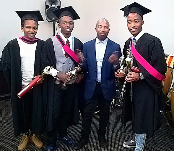 Sipho with graduating drum students holding trophies